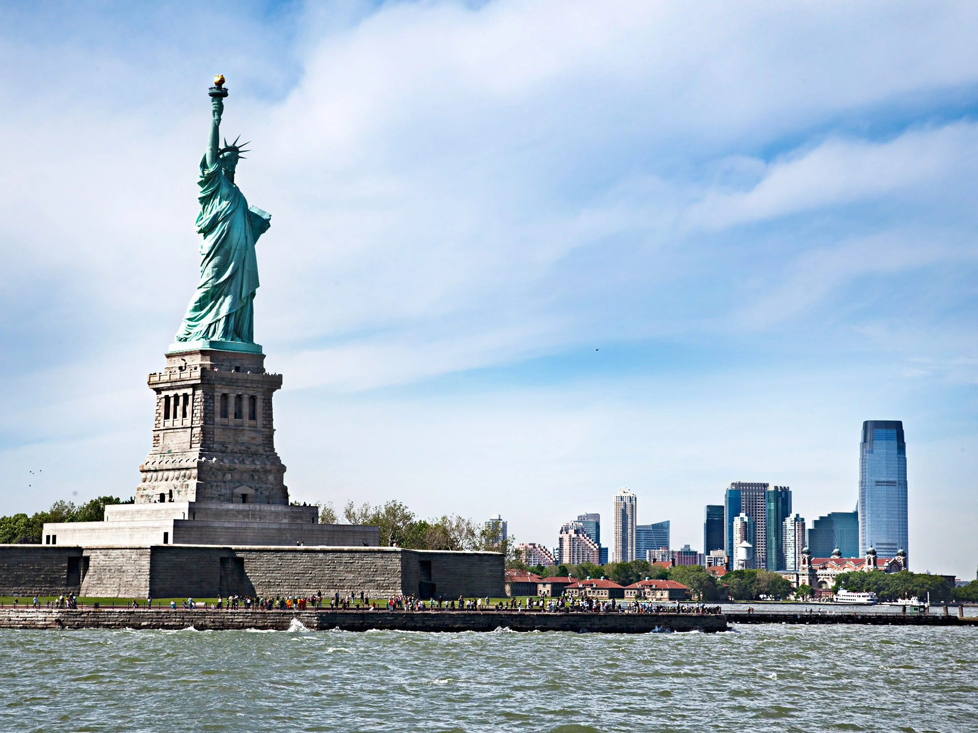 The Statue of Liberty stands tall, holding her torch aloft in New York Harbor, a symbol of freedom and hope.