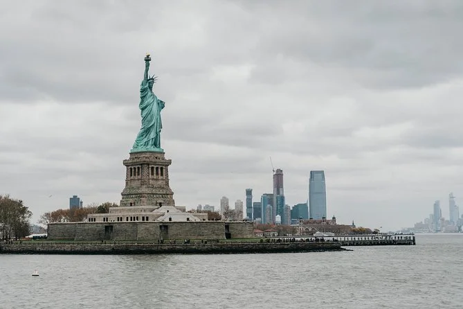 The Statue of Liberty stands proudly in New York Harbor, her torch held high as a beacon of freedom and hope